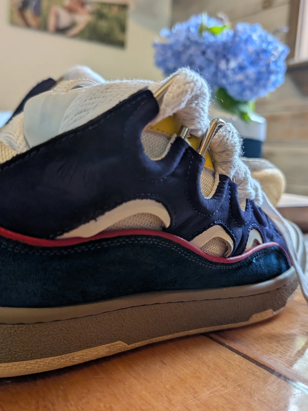 Lanvin Curb Sneakers in a distinct Navy Blue, White, Red, and Yellow colorway.